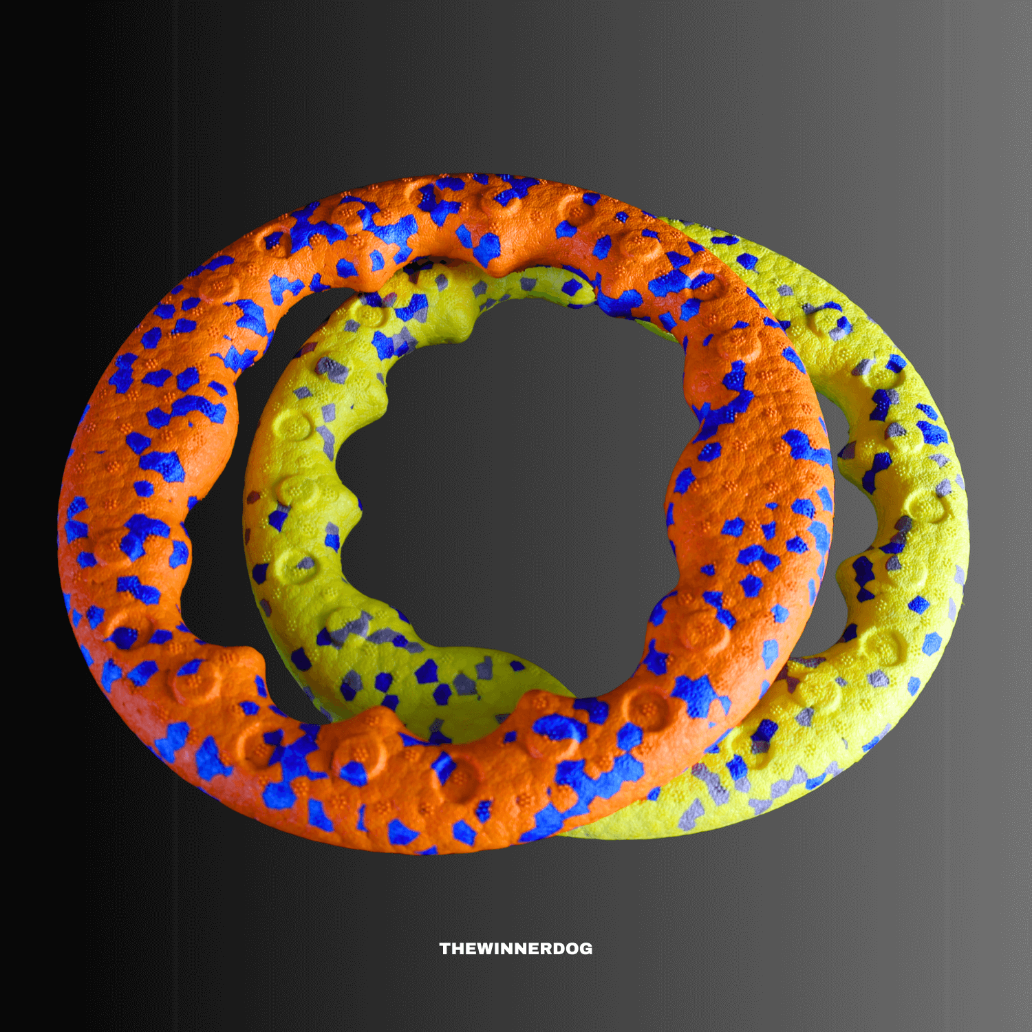 Two colorful dog toys with orange, green, and blue pattern on a black background.